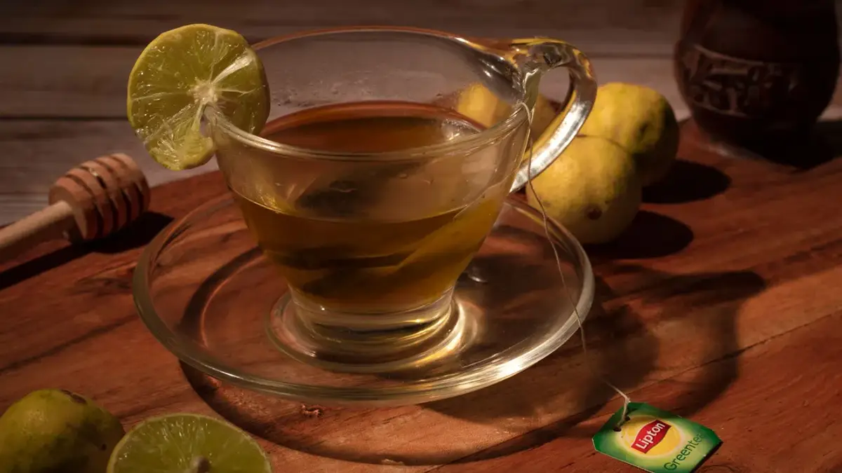 Honey lemon tea cup with steam on a wooden table